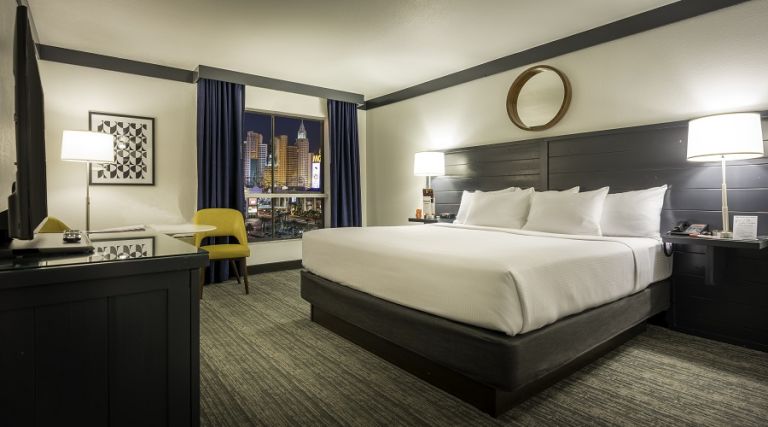 One king bed next to window with Strip view
